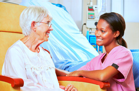 caregiver and senior woman are smiling