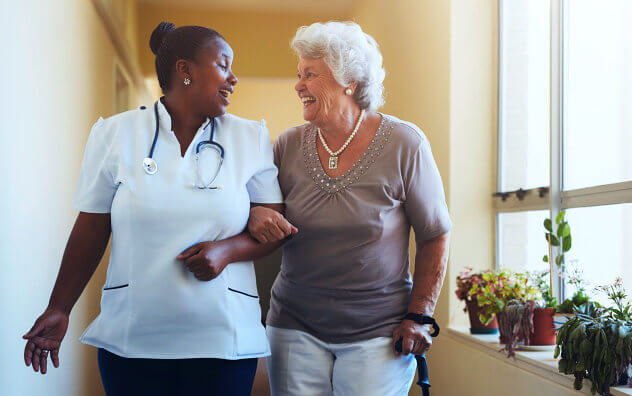 nurse and senior woman are smiling