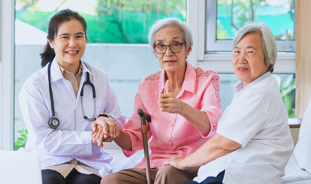 nurse and two seniors are smiling