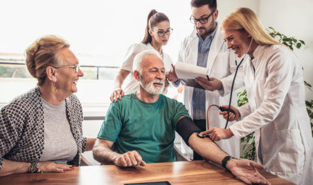 nurse getting metric of blood pressure level of senior man