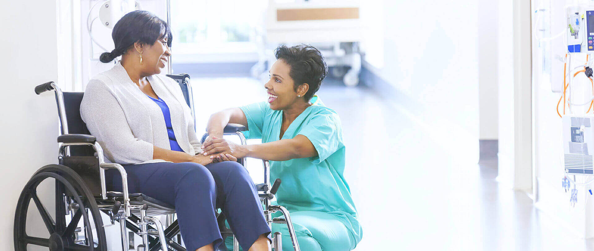 caregiver and senior woman in the wheelchair having a conversation