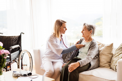 nurse examining a senior woman