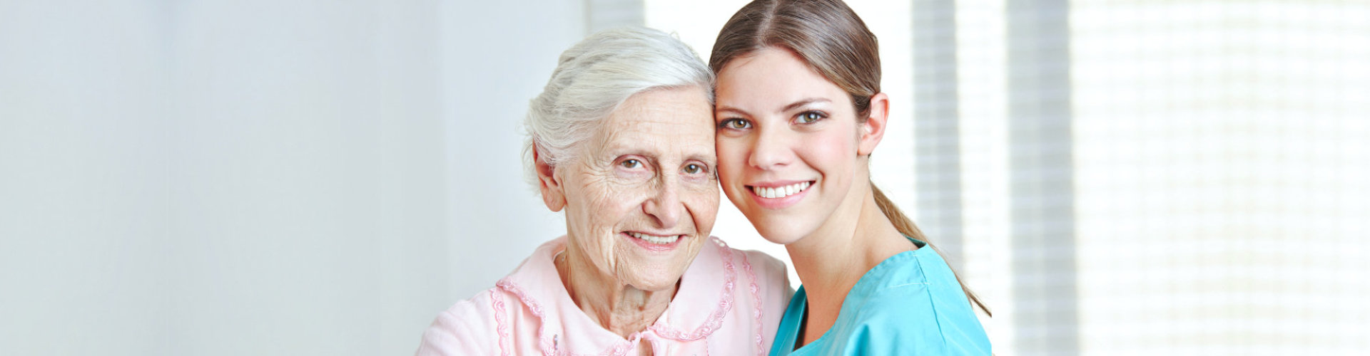 nurse and senior woman are smiling