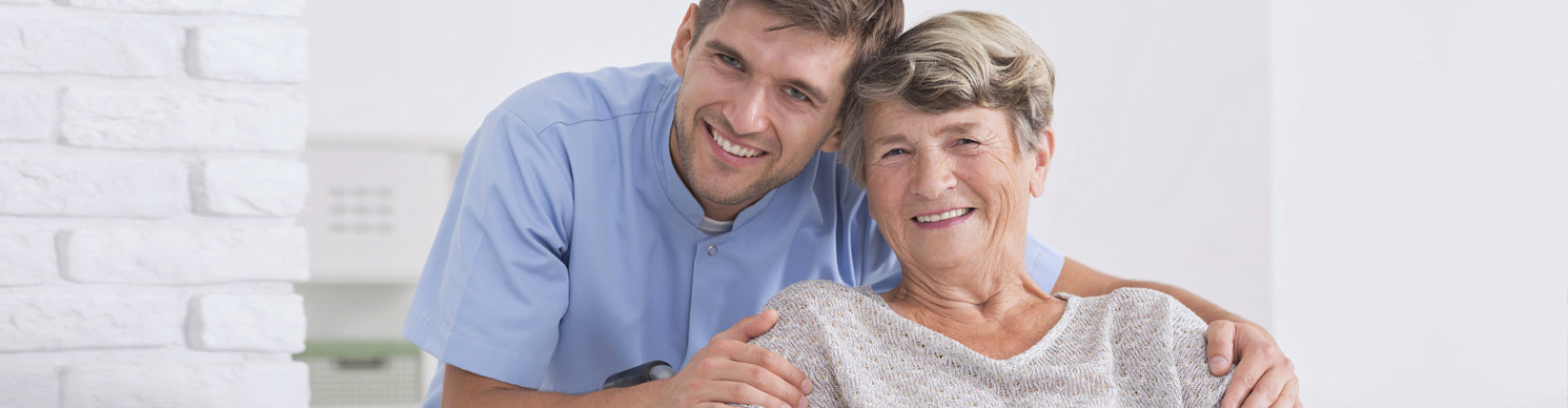 male nurse and senior woman are smiling